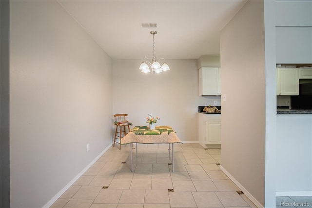 tiled dining area featuring a notable chandelier