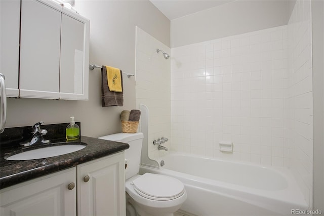 full bathroom with toilet, tiled shower / bath, and vanity