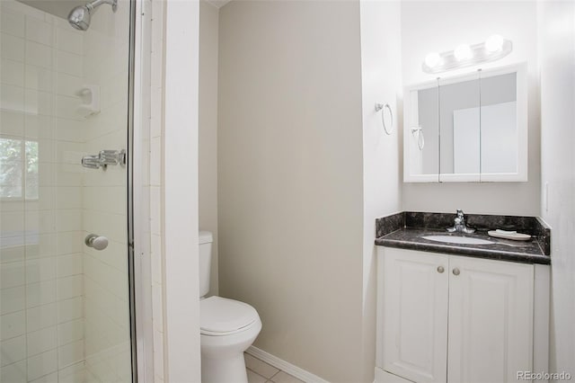 bathroom featuring tile patterned floors, an enclosed shower, vanity, and toilet