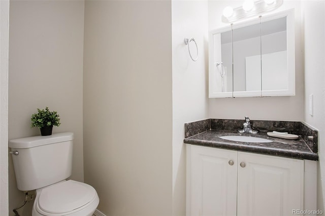 bathroom featuring toilet and vanity