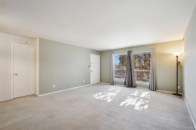 unfurnished room featuring light colored carpet