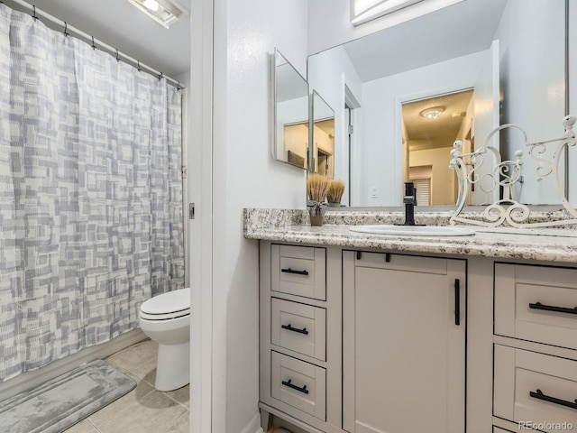 bathroom featuring vanity, curtained shower, tile patterned floors, and toilet