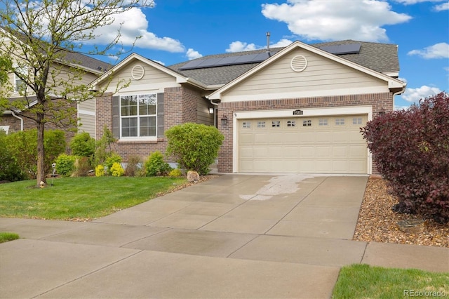 25811 E Archer Ave, Aurora, CO 80018 - view of front of home with brick siding, a front lawn, driveway, and solar panels