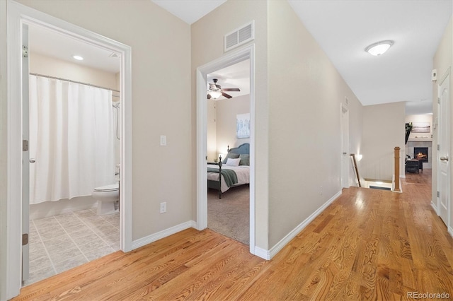 25811 E Archer Ave, Aurora, CO 80018 - hall with light wood-style flooring, an upstairs landing, and baseboards
