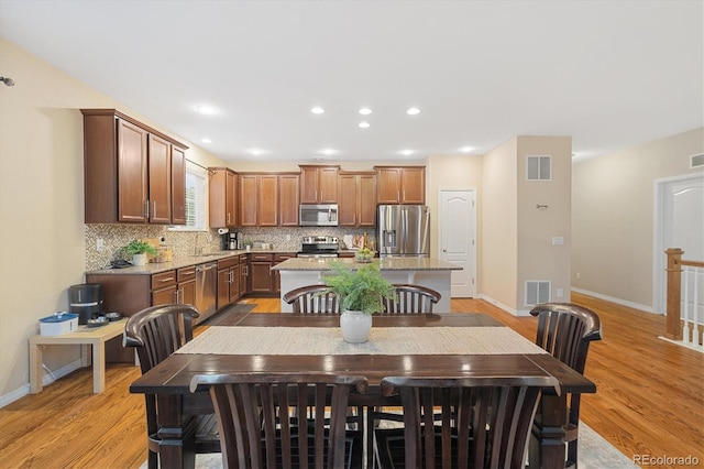 25811 E Archer Ave, Aurora, CO 80018 - dining room featuring light wood-type flooring, baseboards, and recessed lighting