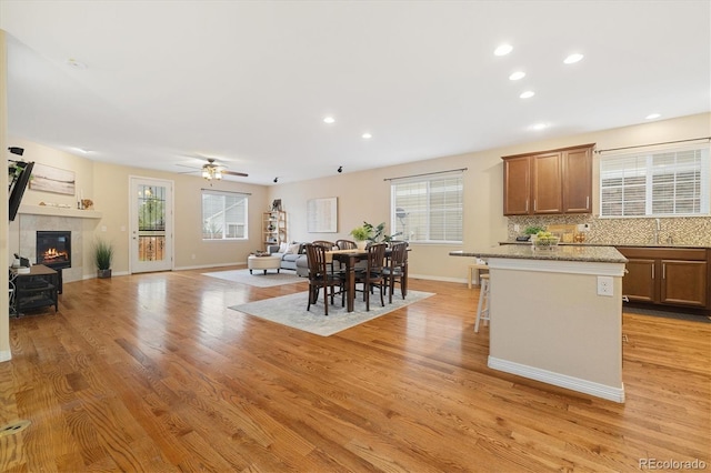 25811 E Archer Ave, Aurora, CO 80018 - kitchen with tasteful backsplash, baseboards, a ceiling fan, light wood-style flooring, and recessed lighting