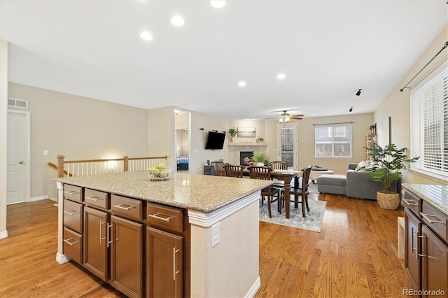 25811 E Archer Ave, Aurora, CO 80018 - kitchen featuring ceiling fan, light wood-style flooring, open floor plan, a center island, and recessed lighting