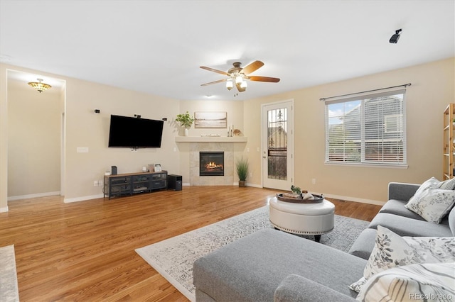 25811 E Archer Ave, Aurora, CO 80018 - living room featuring a ceiling fan, wood finished floors, baseboards, and a tile fireplace