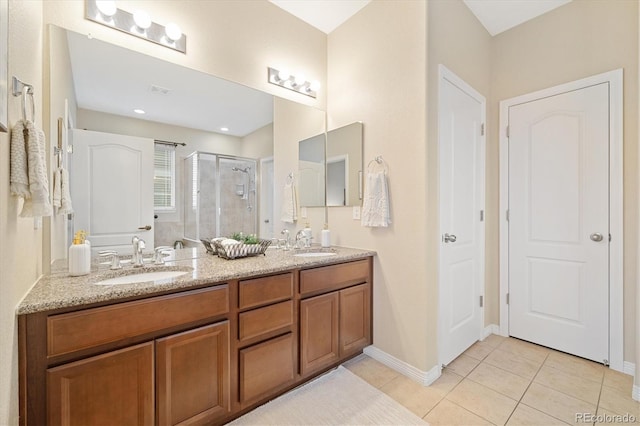 25811 E Archer Ave, Aurora, CO 80018 - bathroom featuring a shower stall, tile patterned floors, double vanity, and baseboards