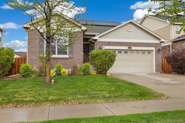 25811 E Archer Ave, Aurora, CO 80018 - view of front of home featuring brick siding, driveway, roof mounted solar panels, and a garage