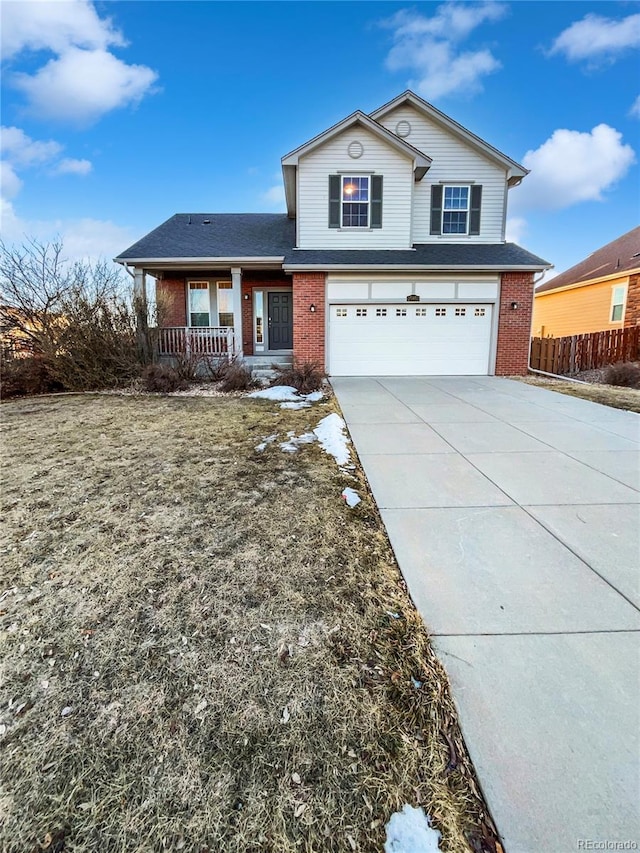 traditional-style home featuring a porch, an attached garage, brick siding, fence, and driveway