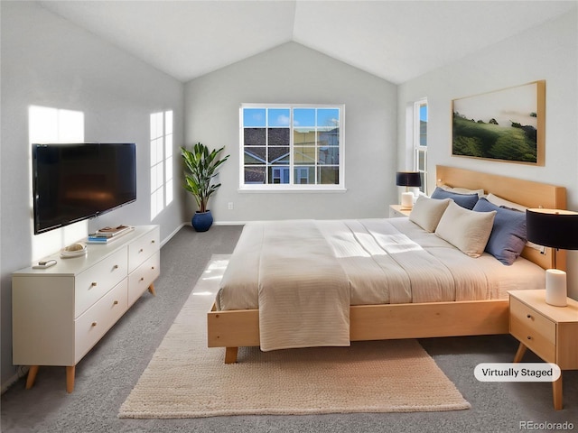 bedroom featuring lofted ceiling, carpet, and baseboards