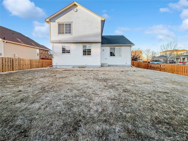 back of house with a fenced backyard