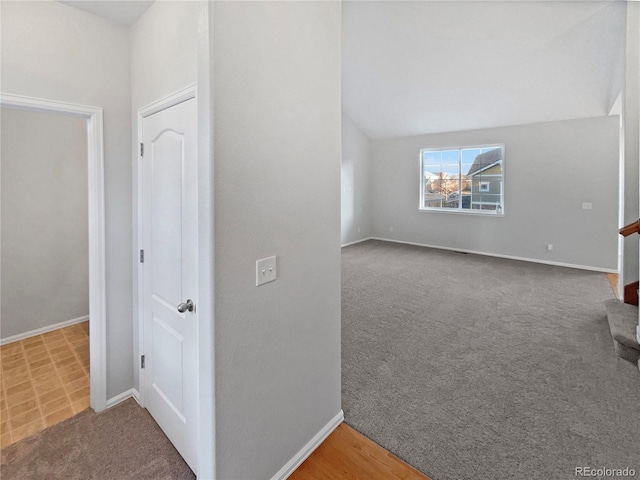 additional living space featuring stairs, carpet, and baseboards