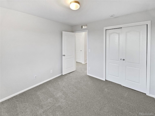 unfurnished bedroom featuring a closet, carpet flooring, visible vents, and baseboards