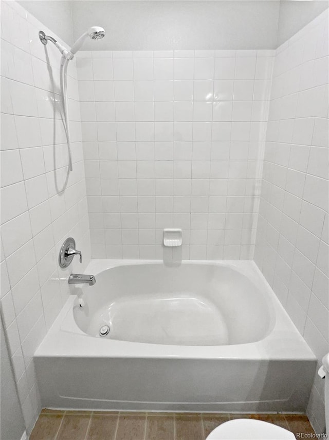 full bath with washtub / shower combination and toilet