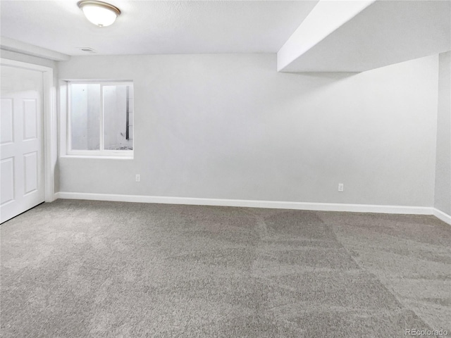 carpeted empty room featuring visible vents and baseboards