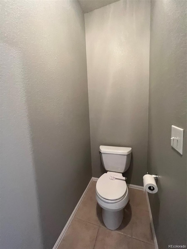 bathroom featuring tile patterned flooring and toilet