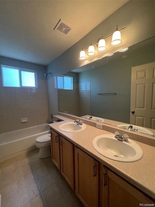 full bathroom with tile patterned floors, vanity, toilet, and tiled shower / bath