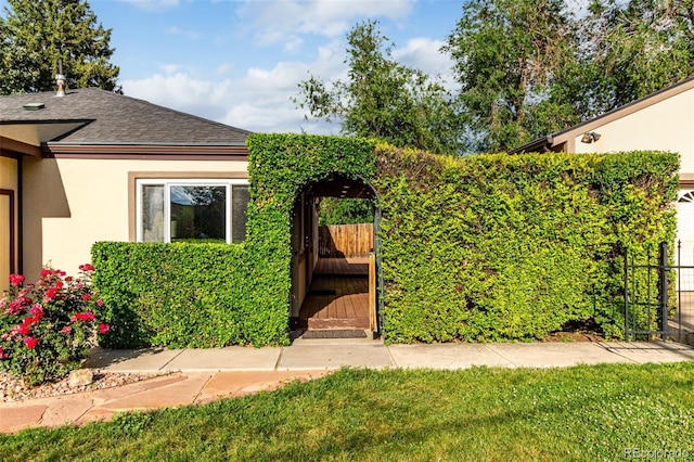 1060 S Eaton St, Lakewood, CO 80226 - entrance to property featuring a gate, stucco siding, and roof with shingles
