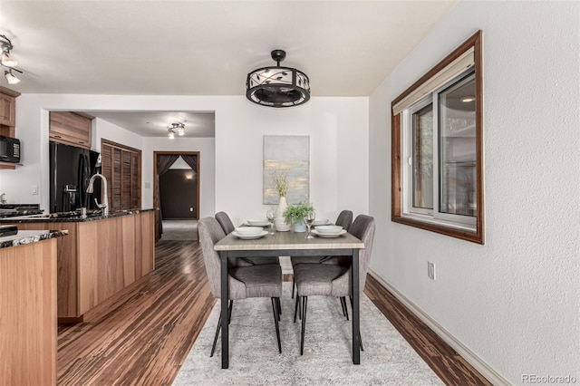 1060 S Eaton St, Lakewood, CO 80226 - dining room featuring dark wood finished floors and baseboards