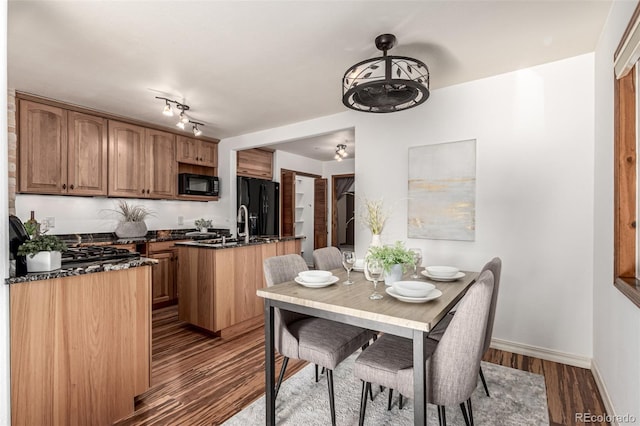 1060 S Eaton St, Lakewood, CO 80226 - dining room featuring dark wood-type flooring and baseboards