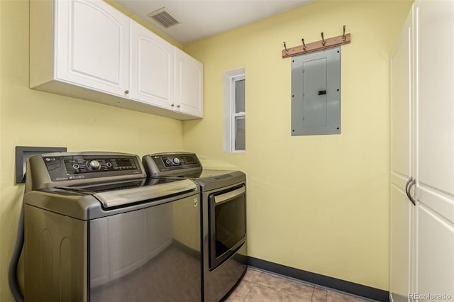 1060 S Eaton St, Lakewood, CO 80226 - laundry area featuring electric panel, washing machine and clothes dryer, cabinet space, and light tile patterned floors