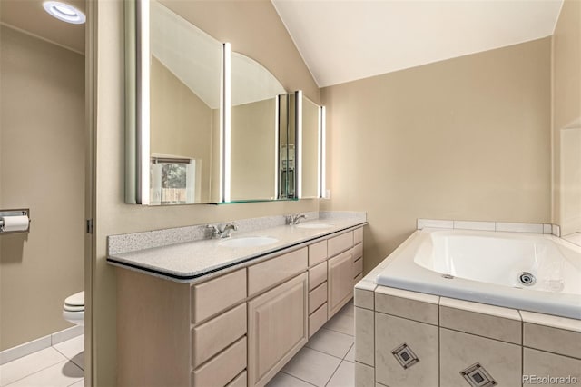 1060 S Eaton St, Lakewood, CO 80226 - full bath with tile patterned flooring, double vanity, a jetted tub, and vaulted ceiling