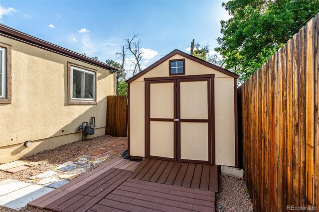 1060 S Eaton St, Lakewood, CO 80226 - wooden terrace featuring a storage shed and a fenced backyard