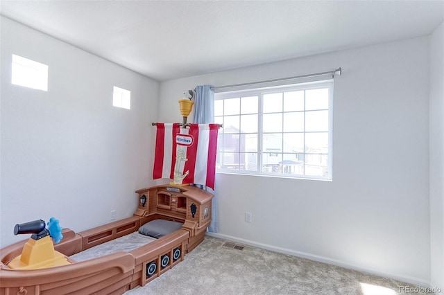 interior space featuring light colored carpet and a healthy amount of sunlight