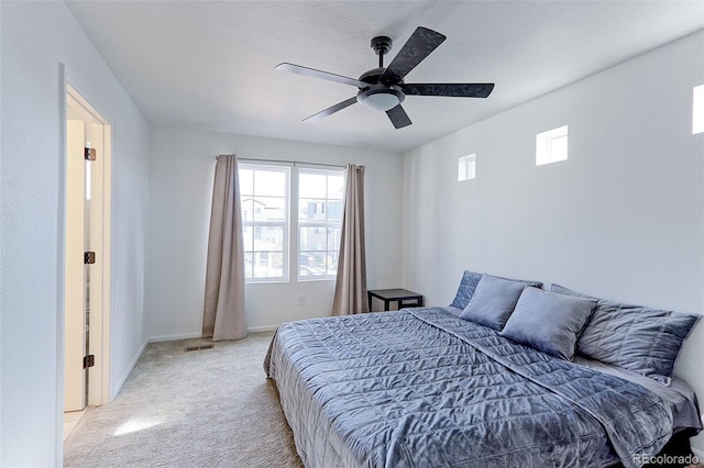 bedroom with ceiling fan and light colored carpet