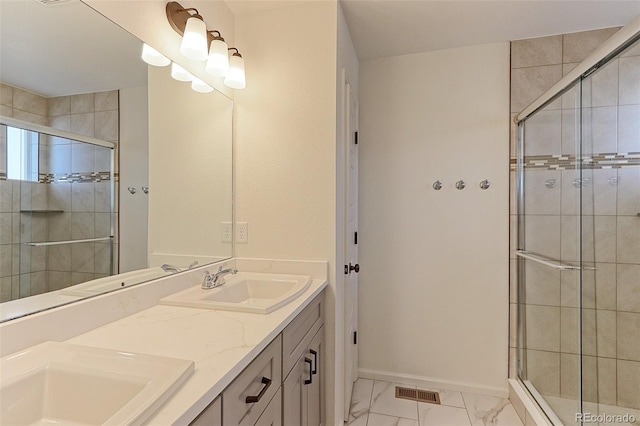 bathroom featuring vanity and a shower with door