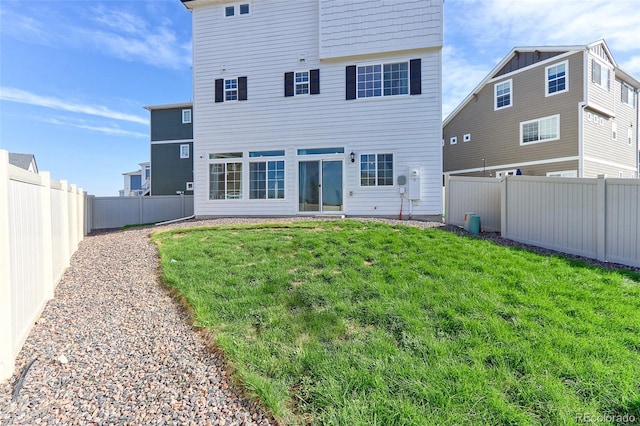 rear view of house with a lawn