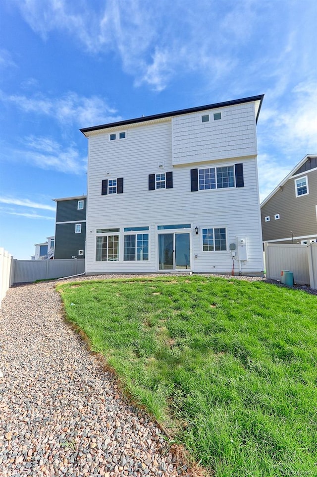 back of house featuring a yard