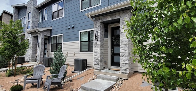 9279 Merino Ct Unit B, Littleton, CO 80125 - rear view of house with stone siding and central AC unit
