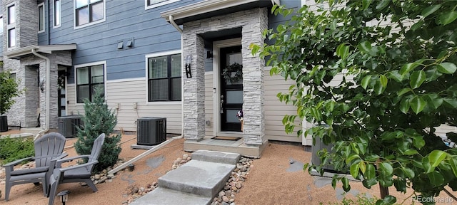 9279 Merino Ct Unit B, Littleton, CO 80125 - entrance to property with stone siding and central air condition unit