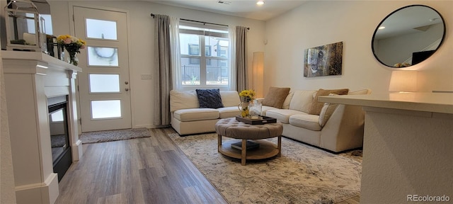 9279 Merino Ct Unit B, Littleton, CO 80125 - living area with wood finished floors, recessed lighting, and a glass covered fireplace