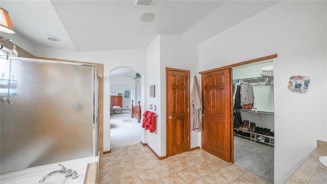9832 N Crystal Lake Dr, Littleton, CO 80125 - full bathroom with a shower stall, a spacious closet, and connected bathroom
