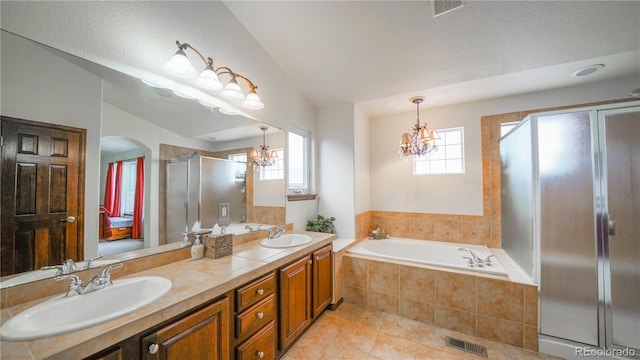 9832 N Crystal Lake Dr, Littleton, CO 80125 - bathroom featuring a chandelier, healthy amount of natural light, a shower stall, and vaulted ceiling