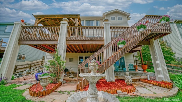 9832 N Crystal Lake Dr, Littleton, CO 80125 - rear view of property featuring stairway, a deck, and a patio