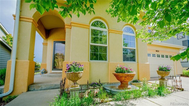 9832 N Crystal Lake Dr, Littleton, CO 80125 - entrance to property with stucco siding and concrete driveway