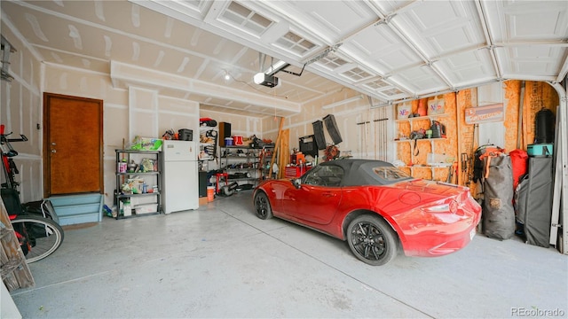 9832 N Crystal Lake Dr, Littleton, CO 80125 - garage featuring freestanding refrigerator and a garage door opener