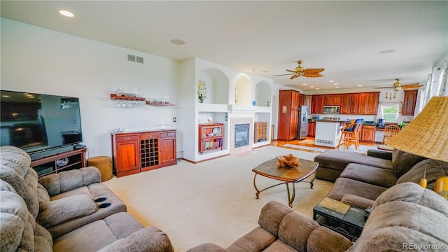 9832 N Crystal Lake Dr, Littleton, CO 80125 - living area with a glass covered fireplace, a ceiling fan, light carpet, recessed lighting, and built in features