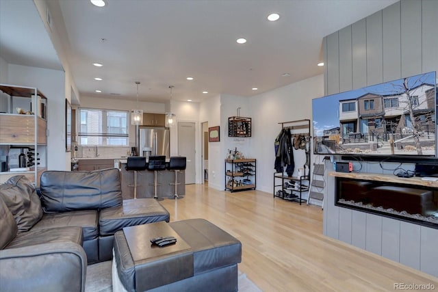 living room with recessed lighting and light wood-style floors