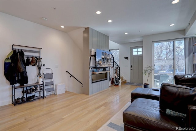 living area with stairway, recessed lighting, and light wood-type flooring