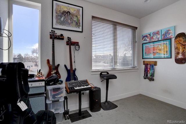 exercise room featuring carpet flooring, plenty of natural light, and baseboards