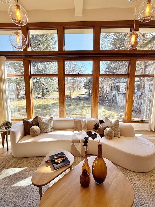 sunroom / solarium featuring beam ceiling