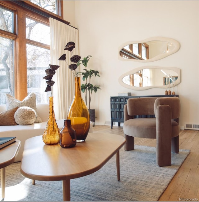 sitting room with visible vents, baseboards, and hardwood / wood-style flooring