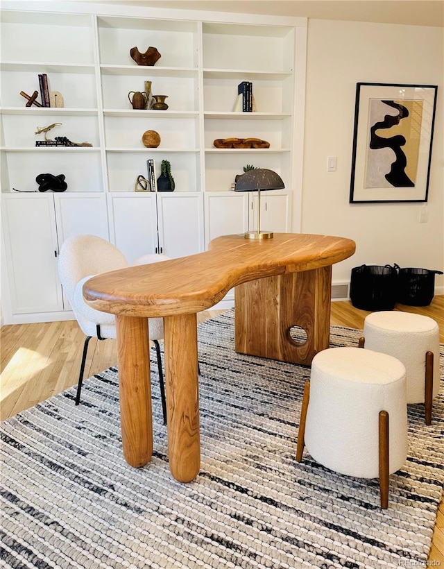 interior space featuring light wood finished floors and baseboards