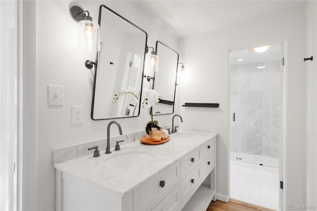 full bath with double vanity, a stall shower, and a sink